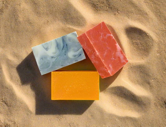 Three colorful soap bars on a white background